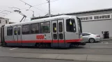 San Francisco tram line N Judah with articulated tram 1405 in the intersection Irving St. & 9th Ave (2021)