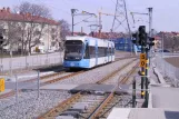 Stockholm tram line 30 Tvärbanan with low-floor articulated tram 408 close by Årstafältet (2003)