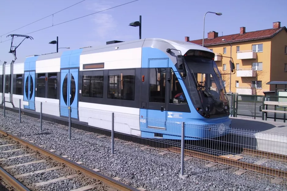 Stockholm tram line 30 Tvärbanan with low-floor articulated tram 408 near Årstafältet (2003)